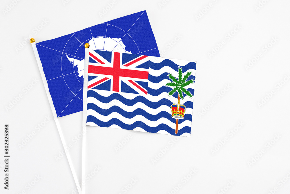 Fototapeta premium British Indian Ocean Territory and Antarctica stick flags on white background. High quality fabric, miniature national flag. Peaceful global concept.White floor for copy space.