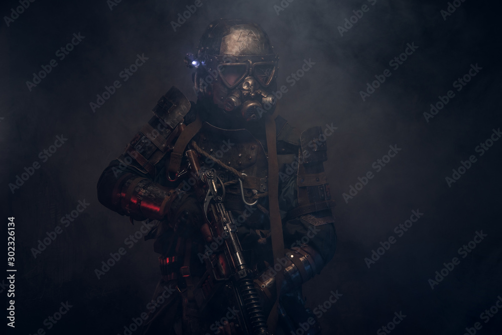 Dark post apocalypse knight is posing for photographer in light smoke. Dark post apocalypse knight is posing for photographer in light smoke.