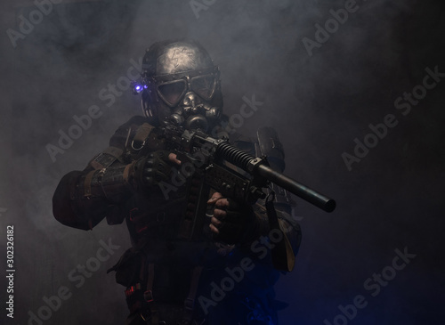 Dark post apocalypse knight is posing for photographer in light smoke.