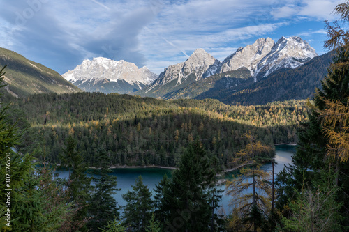 Zugspitze glacier peaks raising above autumn forest