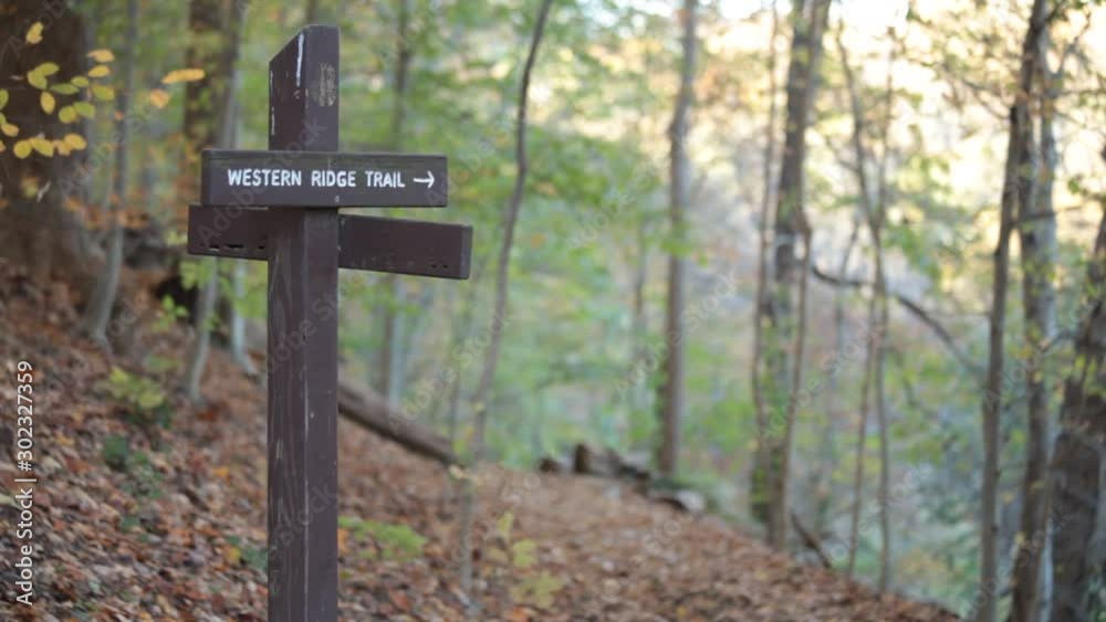 Medium shot of Western Ridge Trail sign, male hiker passes by - Rock Creek Park - Washington, DC - Autumn Medium shot of Western Ridge Trail sign, male hiker passes by - Rock Creek Park - Washington, DC - Autumn