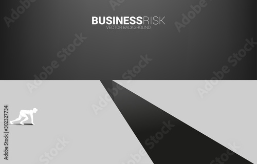 silhouette of businessman ready to run to jumping over the gap. concept of business challenge risk.