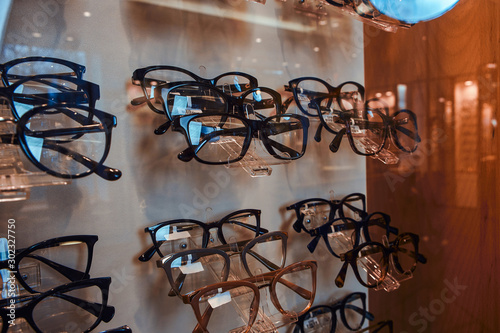 Showcase at optician's shop, big variety of different frames for glasses.