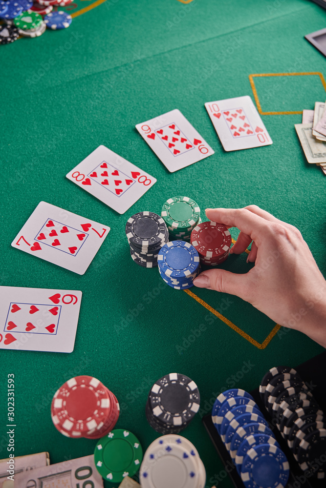 A straight flush, laid out on the table and a lot of chips. Poker, Casino, Winning combination. Player raises bets and wins A straight flush, laid out on the table and a lot of chips. Poker, Casino, Winning combination. Player raises bets and wins