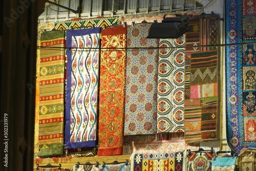 Handmade carpets displayed on a street stall at grand bazar.
