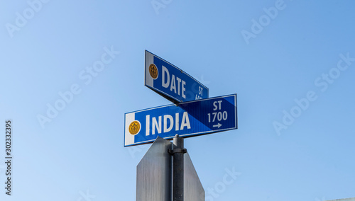 Date and India street sign with blue sky background