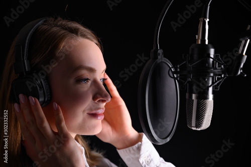 Singer, blogger, voice acting. Work in the studio with a studio microphone.
