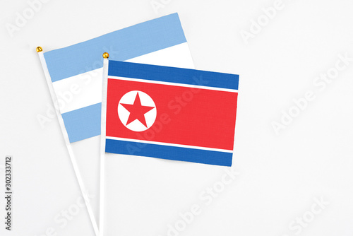 North Korea and Argentina stick flags on white background. High quality fabric, miniature national flag. Peaceful global concept.White floor for copy space. Free Download North Korea and Argentina stick flags on white background. High quality fabric, miniature national flag. Peaceful global concept.White floor for copy space. - GFXLoad