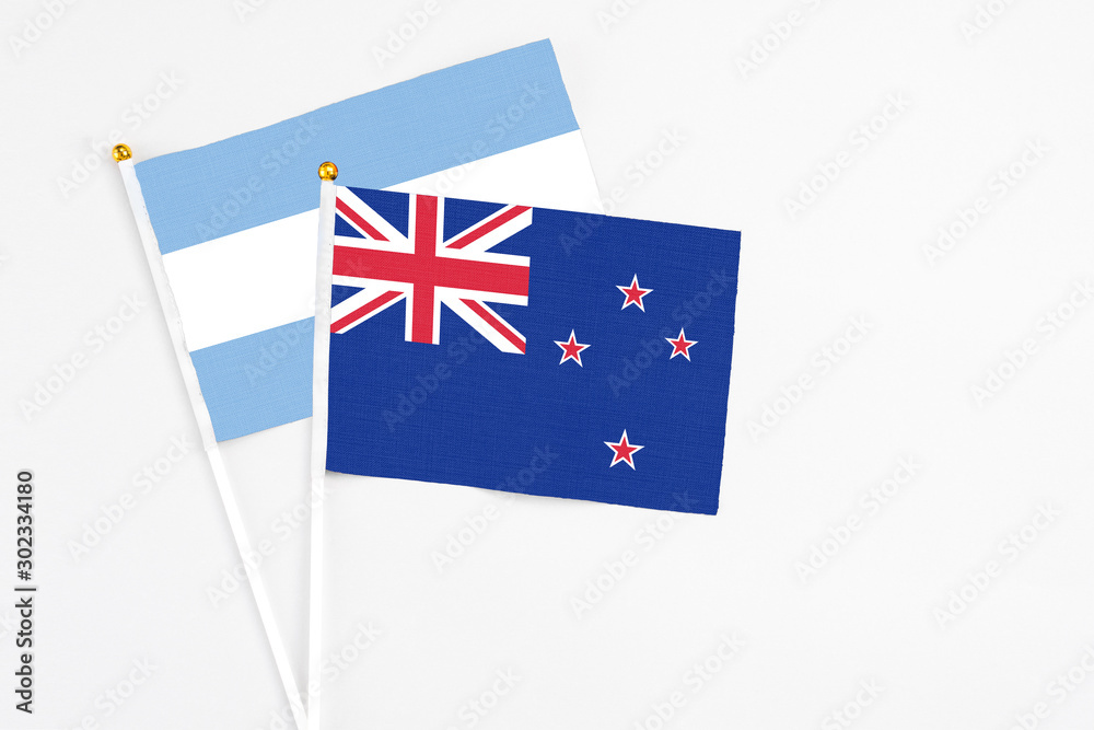 New Zealand and Argentina stick flags on white background. High quality fabric, miniature national flag. Peaceful global concept.White floor for copy space. New Zealand and Argentina stick flags on white background. High quality fabric, miniature national flag. Peaceful global concept.White floor for copy space.