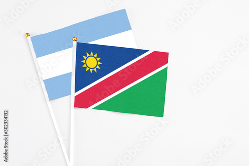 Free Download Namibia and Argentina stick flags on white background. High quality fabric, miniature national flag. Peaceful global concept.White floor for copy space. - GFXLoad