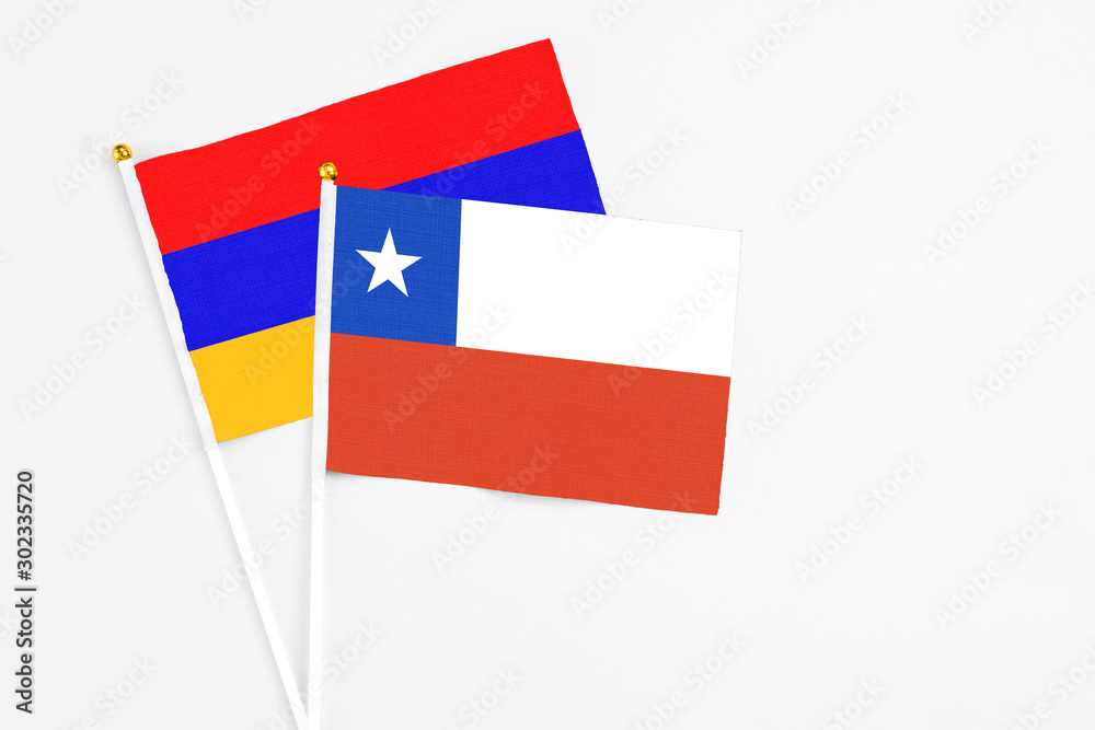 Chile and Armenia stick flags on white background. High quality fabric, miniature national flag. Peaceful global concept.White floor for copy space. Chile and Armenia stick flags on white background. High quality fabric, miniature national flag. Peaceful global concept.White floor for copy space.