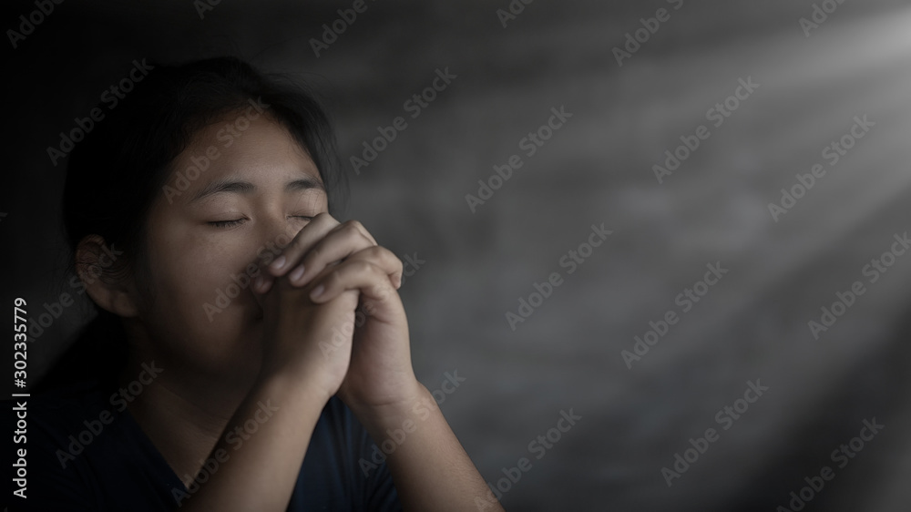 Girl while praying for christian religion with blurred of her body background. Girl while praying for christian religion with blurred of her body background.