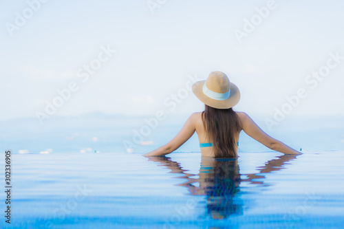 Portrait beautiful young asian women happy smile relax outdoor swimming pool in resort