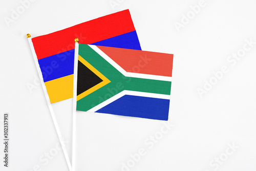 South Africa and Armenia stick flags on white background. High quality fabric  miniature national flag. Peaceful global concept.White floor for copy space.