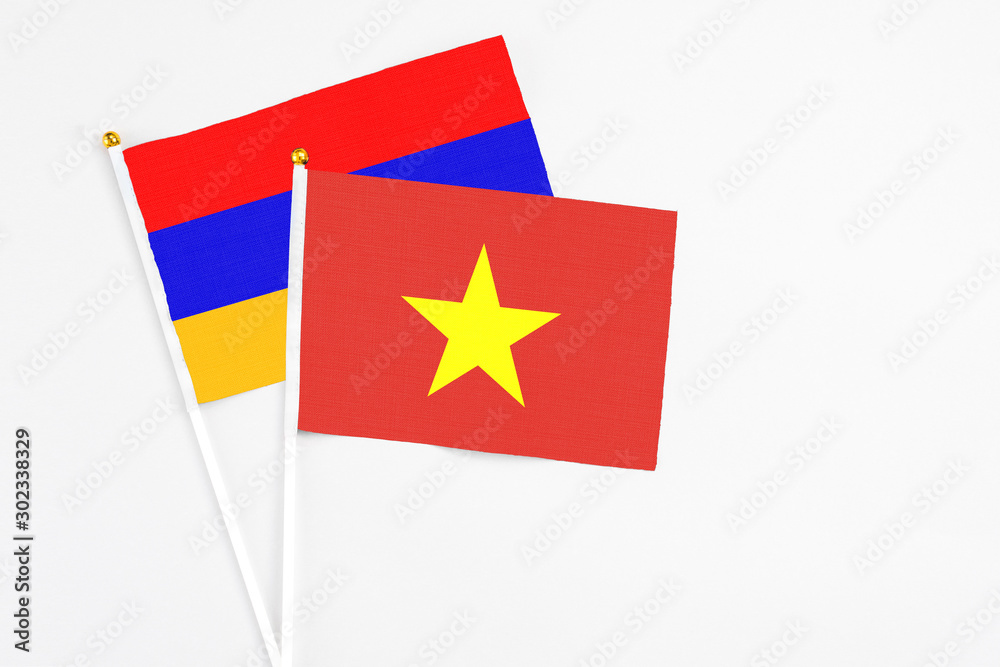 Vietnam and Armenia stick flags on white background. High quality fabric, miniature national flag. Peaceful global concept.White floor for copy space. Vietnam and Armenia stick flags on white background. High quality fabric, miniature national flag. Peaceful global concept.White floor for copy space.
