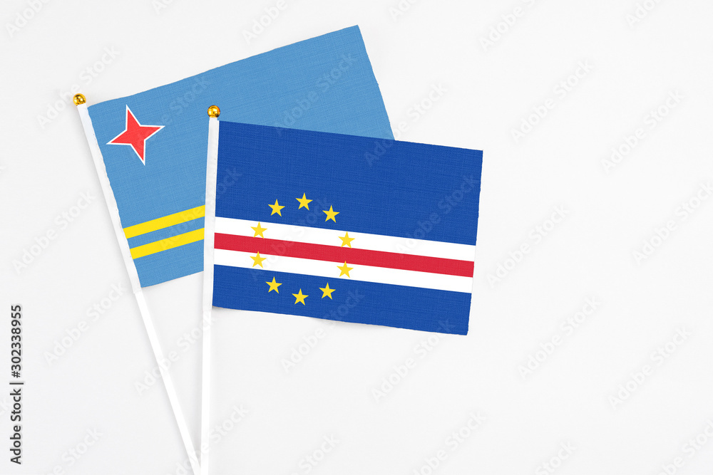 Cape Verde and Aruba stick flags on white background. High quality fabric, miniature national flag. Peaceful global concept.White floor for copy space. Cape Verde and Aruba stick flags on white background. High quality fabric, miniature national flag. Peaceful global concept.White floor for copy space.