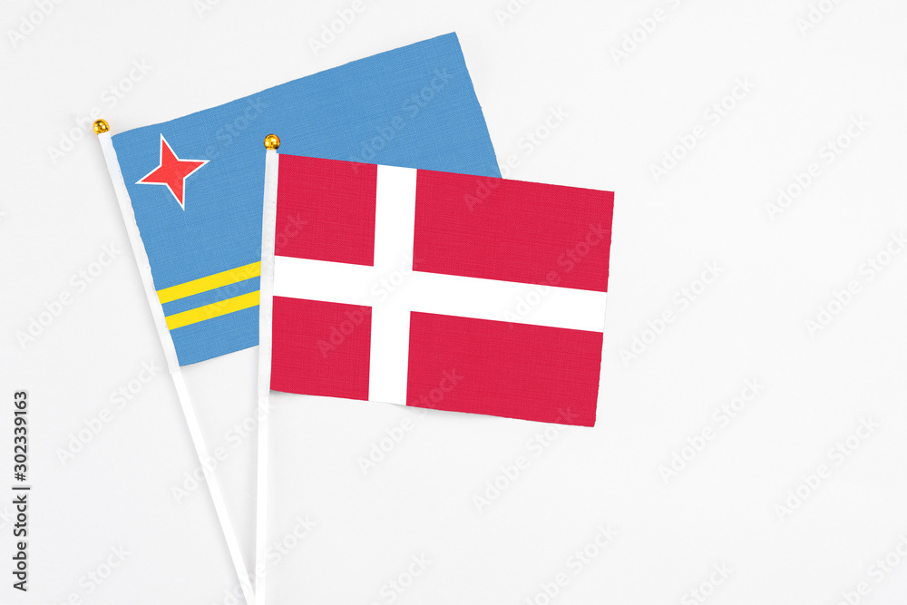Denmark and Aruba stick flags on white background. High quality fabric, miniature national flag. Peaceful global concept.White floor for copy space.