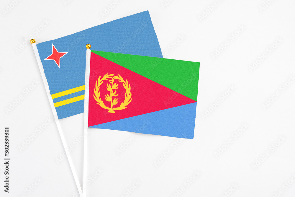 Eritrea and Aruba stick flags on white background. High quality fabric, miniature national flag. Peaceful global concept.White floor for copy space. Eritrea and Aruba stick flags on white background. High quality fabric, miniature national flag. Peaceful global concept.White floor for copy space.