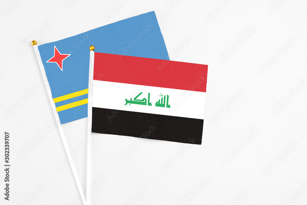 Iraq and Aruba stick flags on white background. High quality fabric, miniature national flag. Peaceful global concept.White floor for copy space. Iraq and Aruba stick flags on white background. High quality fabric, miniature national flag. Peaceful global concept.White floor for copy space.