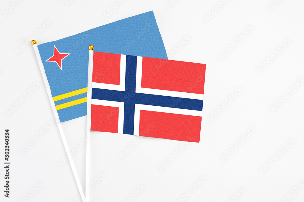 Norway and Aruba stick flags on white background. High quality fabric, miniature national flag. Peaceful global concept.White floor for copy space.
