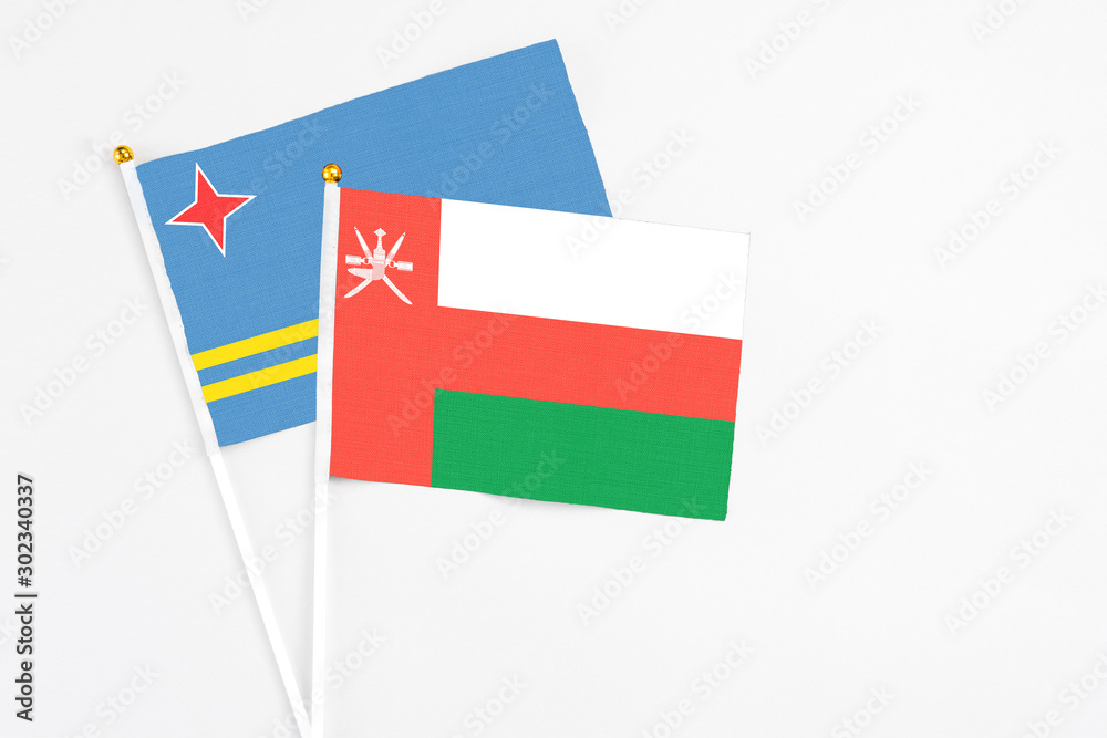 Oman and Aruba stick flags on white background. High quality fabric, miniature national flag. Peaceful global concept.White floor for copy space. Oman and Aruba stick flags on white background. High quality fabric, miniature national flag. Peaceful global concept.White floor for copy space.