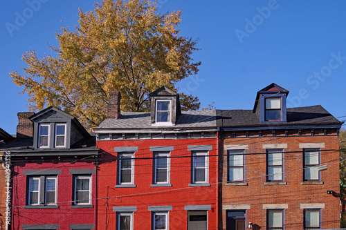 Photography Old brick houses with dormer windows painted in cheerful colors