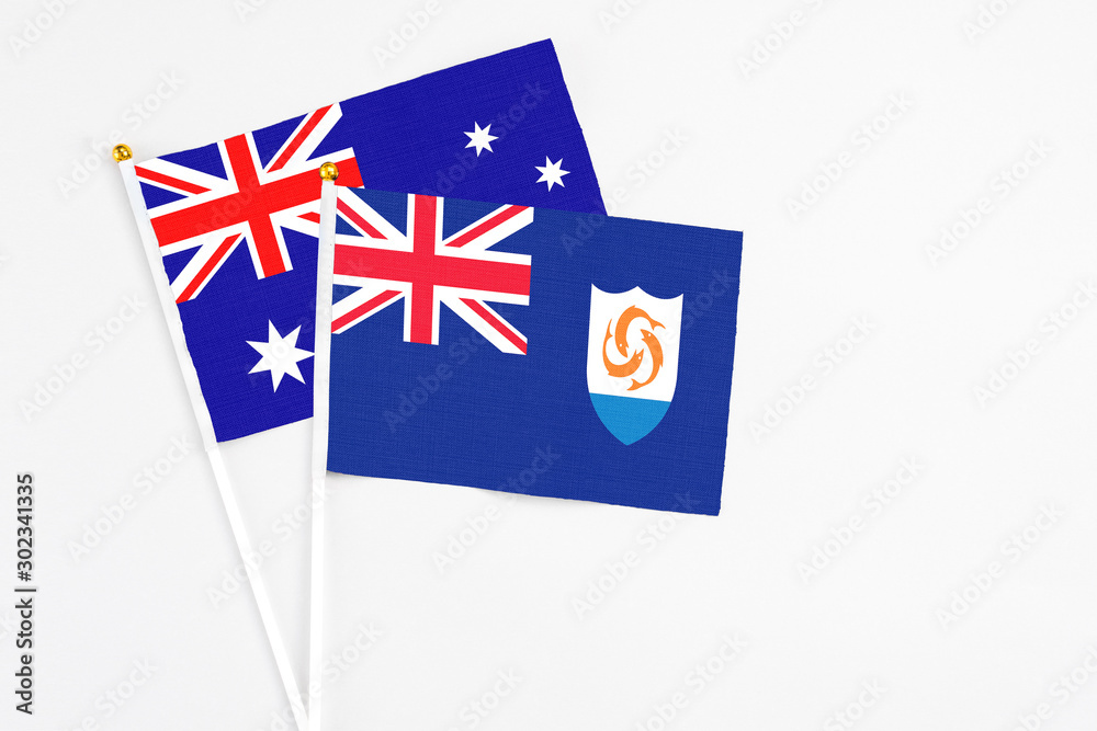 Fototapeta premium Anguilla and Australia stick flags on white background. High quality fabric, miniature national flag. Peaceful global concept.White floor for copy space.