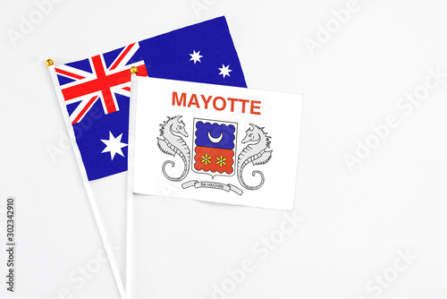 Mayotte and Australia stick flags on white background. High quality fabric, miniature national flag. Peaceful global concept.White floor for copy space.