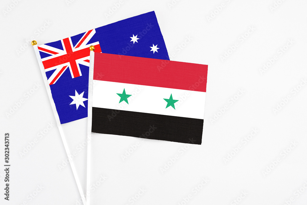 Syria and Australia stick flags on white background. High quality fabric, miniature national flag. Peaceful global concept.White floor for copy space.