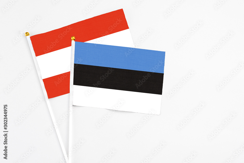Estonia and Austria stick flags on white background. High quality fabric, miniature national flag. Peaceful global concept.White floor for copy space. Estonia and Austria stick flags on white background. High quality fabric, miniature national flag. Peaceful global concept.White floor for copy space.