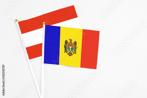 Moldova and Austria stick flags on white background. High quality fabric, miniature national flag. Peaceful global concept.White floor for copy space.