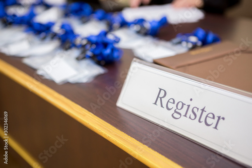 Fototapeta Registration point on the information desk in front of the  seminar room