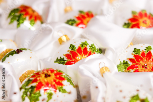 Christmas decorations white balls with painted with flowers and glitter and rhinestones packed in a silk white cloth