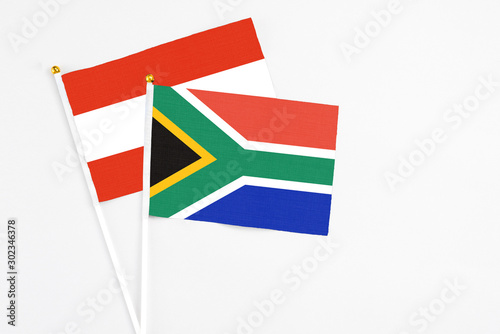 Free Download South Africa and Austria stick flags on white background. High quality fabric, miniature national flag. Peaceful global concept.White floor for copy space. - GFXLoad
