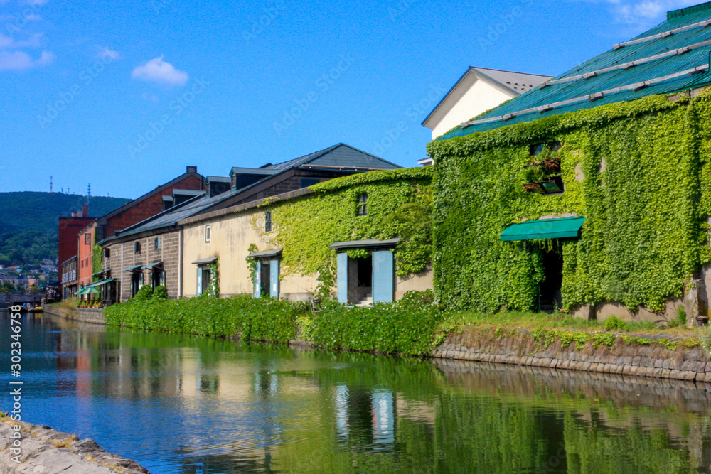 Beautiful scenery of Otaru wearhouses along the Otaru canal in summer with blue sky in background. Beautiful scenery of Otaru wearhouses along the Otaru canal in summer with blue sky in background.