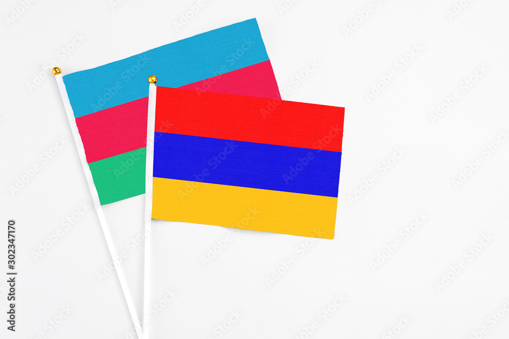 Armenia and Azerbaijan stick flags on white background. High quality fabric, miniature national flag. Peaceful global concept.White floor for copy space. Armenia and Azerbaijan stick flags on white background. High quality fabric, miniature national flag. Peaceful global concept.White floor for copy space.