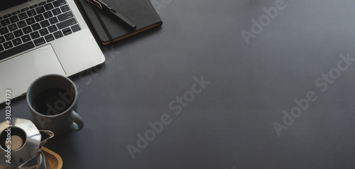 Top view of trendy workplace with laptop computer and copy space with office supplies