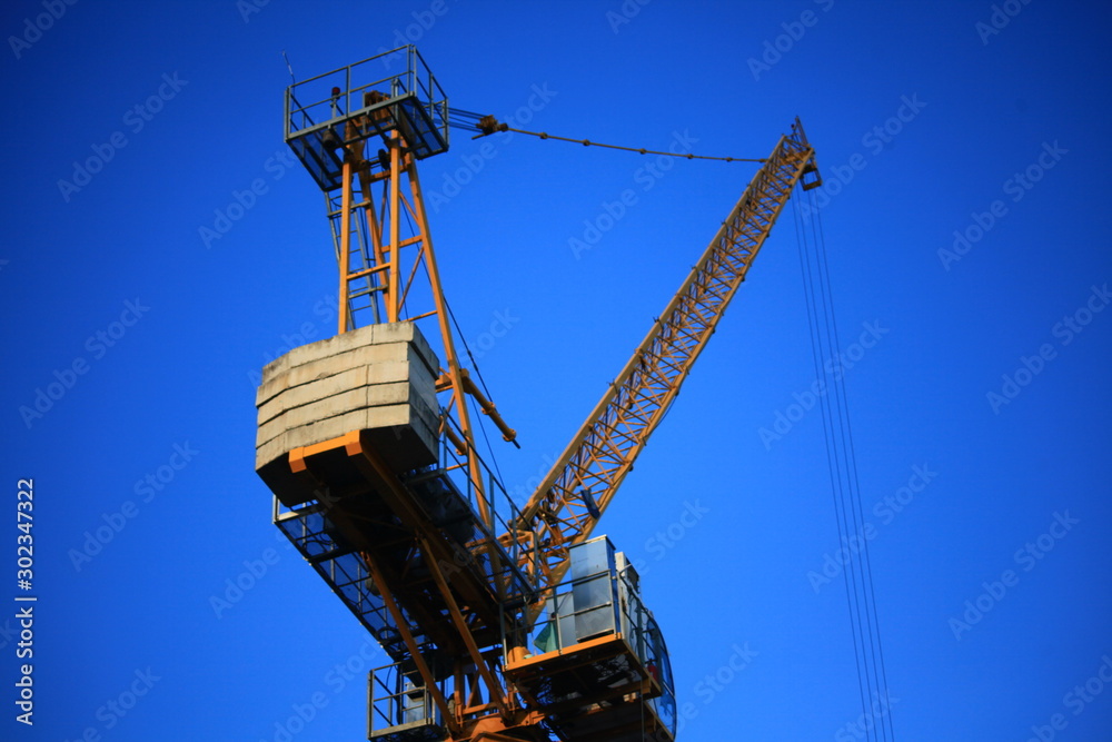 A yellow crane with a blue sky