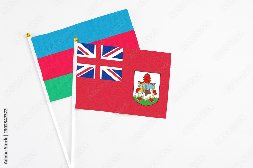 Bermuda and Azerbaijan stick flags on white background. High quality fabric, miniature national flag. Peaceful global concept.White floor for copy space.