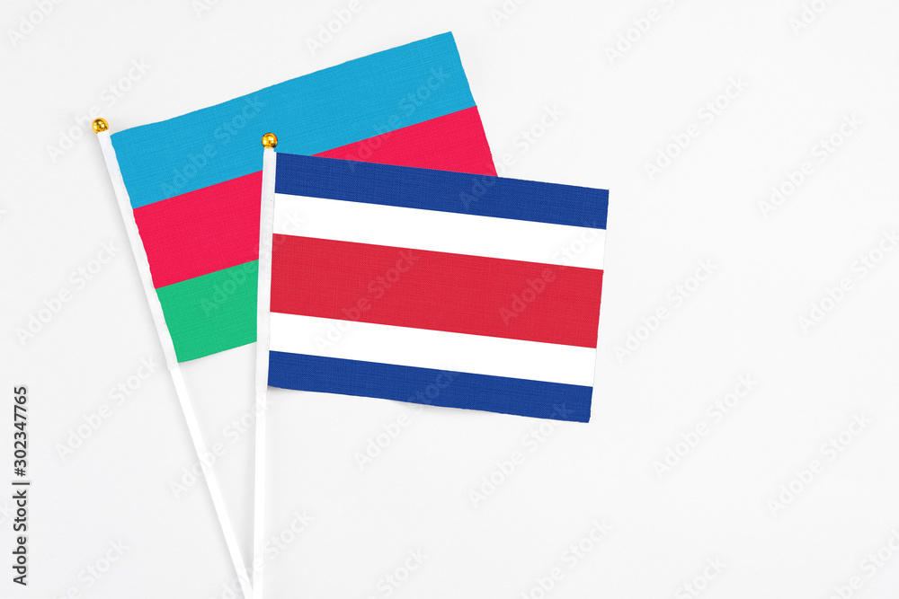 Costa Rica and Azerbaijan stick flags on white background. High quality fabric, miniature national flag. Peaceful global concept.White floor for copy space. Costa Rica and Azerbaijan stick flags on white background. High quality fabric, miniature national flag. Peaceful global concept.White floor for copy space.