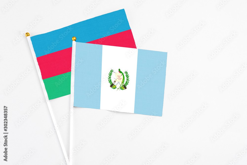 Guatemala and Azerbaijan stick flags on white background. High quality fabric, miniature national flag. Peaceful global concept.White floor for copy space. Guatemala and Azerbaijan stick flags on white background. High quality fabric, miniature national flag. Peaceful global concept.White floor for copy space.