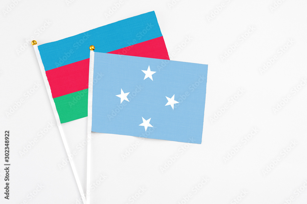 Micronesia and Azerbaijan stick flags on white background. High quality fabric, miniature national flag. Peaceful global concept.White floor for copy space. Micronesia and Azerbaijan stick flags on white background. High quality fabric, miniature national flag. Peaceful global concept.White floor for copy space.