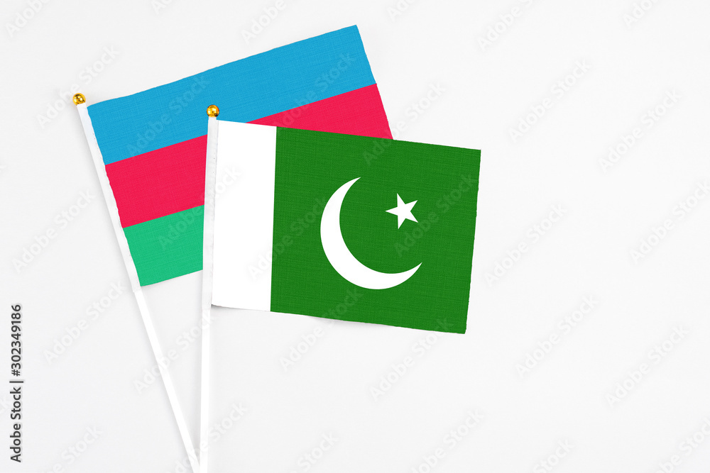 Pakistan and Azerbaijan stick flags on white background. High quality fabric, miniature national flag. Peaceful global concept.White floor for copy space. Pakistan and Azerbaijan stick flags on white background. High quality fabric, miniature national flag. Peaceful global concept.White floor for copy space.