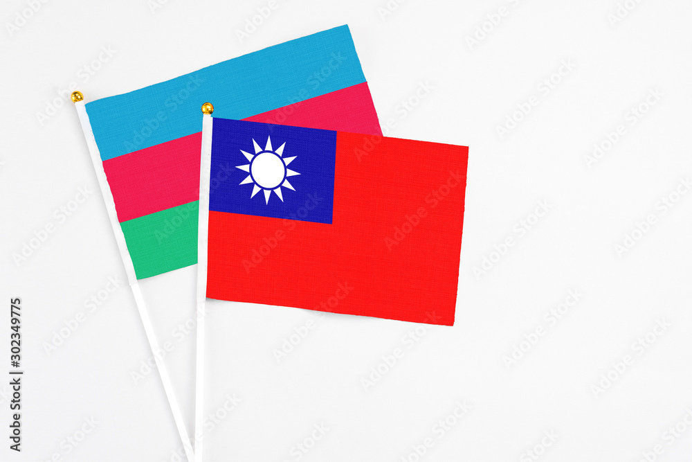 Taiwan and Azerbaijan stick flags on white background. High quality fabric, miniature national flag. Peaceful global concept.White floor for copy space.