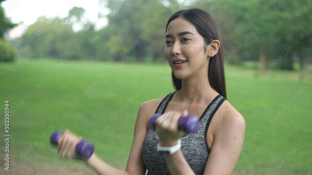 Exercise concepts. Beautiful women are exercising to build strong muscles in the garden. 4k Resolution. Exercise concepts. Beautiful women are exercising to build strong muscles in the garden. 4k Resolution.