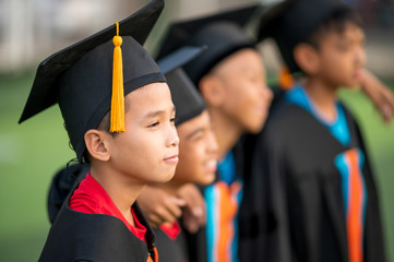 A group of boys are happy on their graduation day at school.