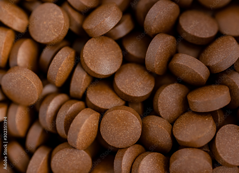 Brown iron supplement pills in the hands Brown iron supplement pills in the hands