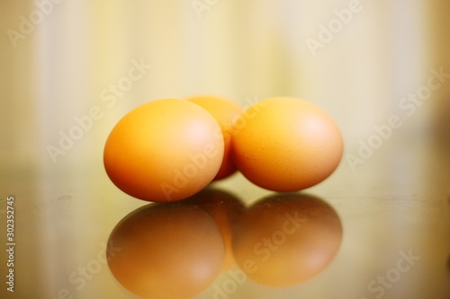 Three eggs on a wooden floor