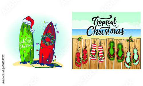 decar surfboards for christmas and new year, decarings from light garlands and holly woven wreath for christmas, tropical beach on vacation