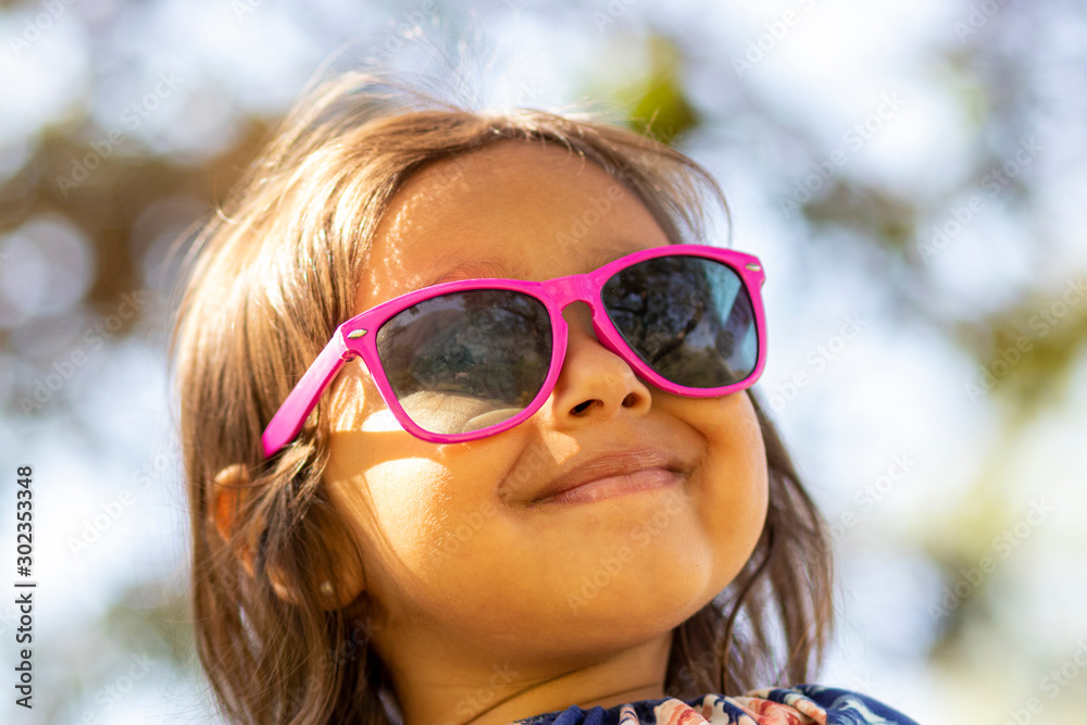 Cute little girl with pink sunglasses Cute little girl with pink sunglasses